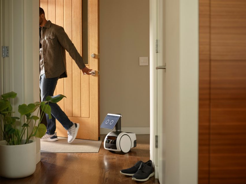 Astro robot and a man shutting a door