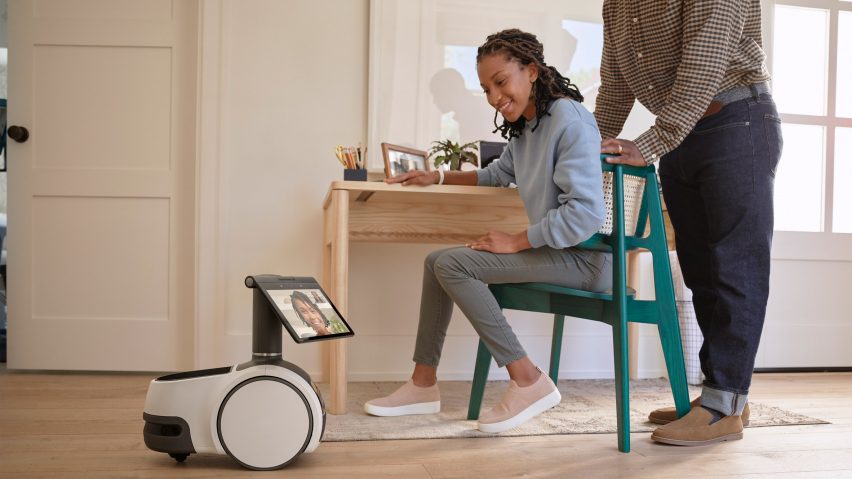 A woman and the Astro robot by Amazon