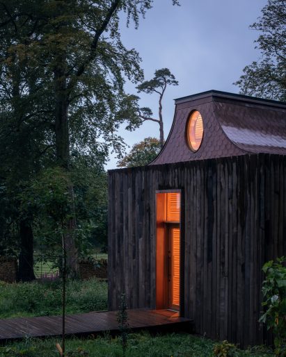 Night view of entrance to The Beezantium by Invisible Studio at The Newt in Somerset