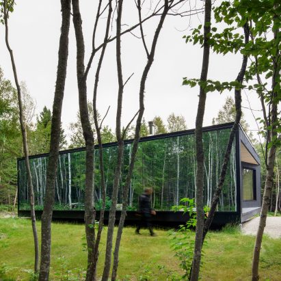The cabin is surrounded by trees