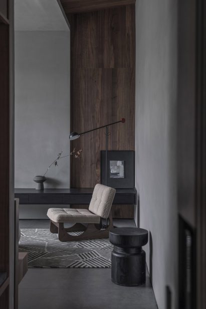 Seating nook with Boucle armchair in hotel interior by Gad Line+ Studio