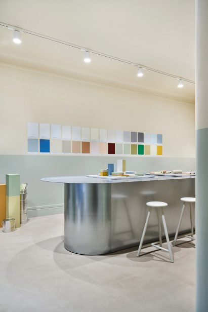 Galvanised steel table in front of a wall of paint swatches in the Cover Story Helsinki store