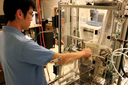 A man using equipment to turn waste into fuel