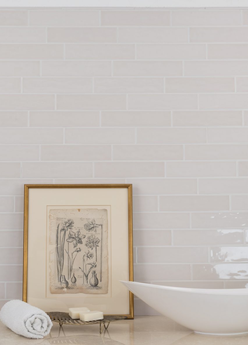 Habitat tiles in the alabaster glossy finish on a wall with a photo frame