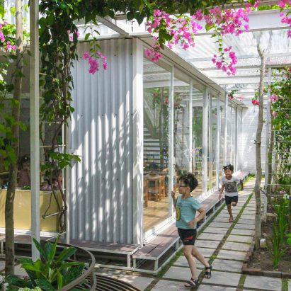 Plant-covered mesh panels surround preschool in Vietnam by HGAA