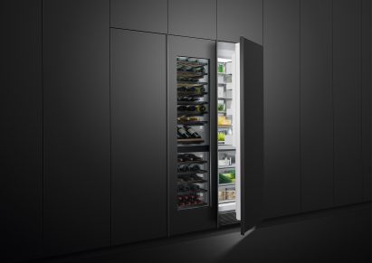 Fridge and wine chiller partially concealed inside a wall of in-set charcoal-toned cabinets