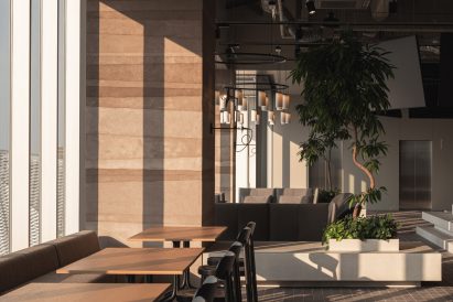 Cafe-style seating area with planters in Kadokawa's office in Tokorozawa