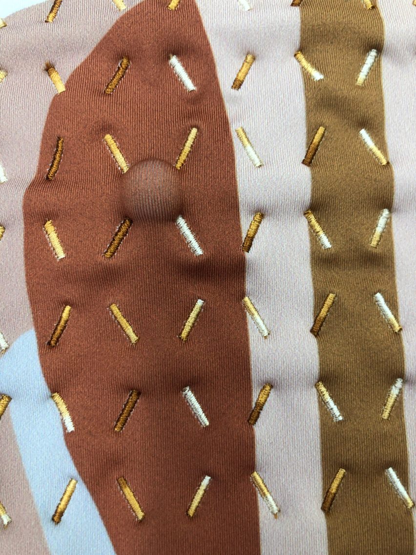 The Healing Imprint garment with a massage ball positioned in a valley of one channel