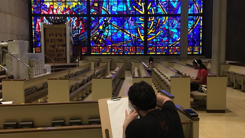 Student sits inside a church