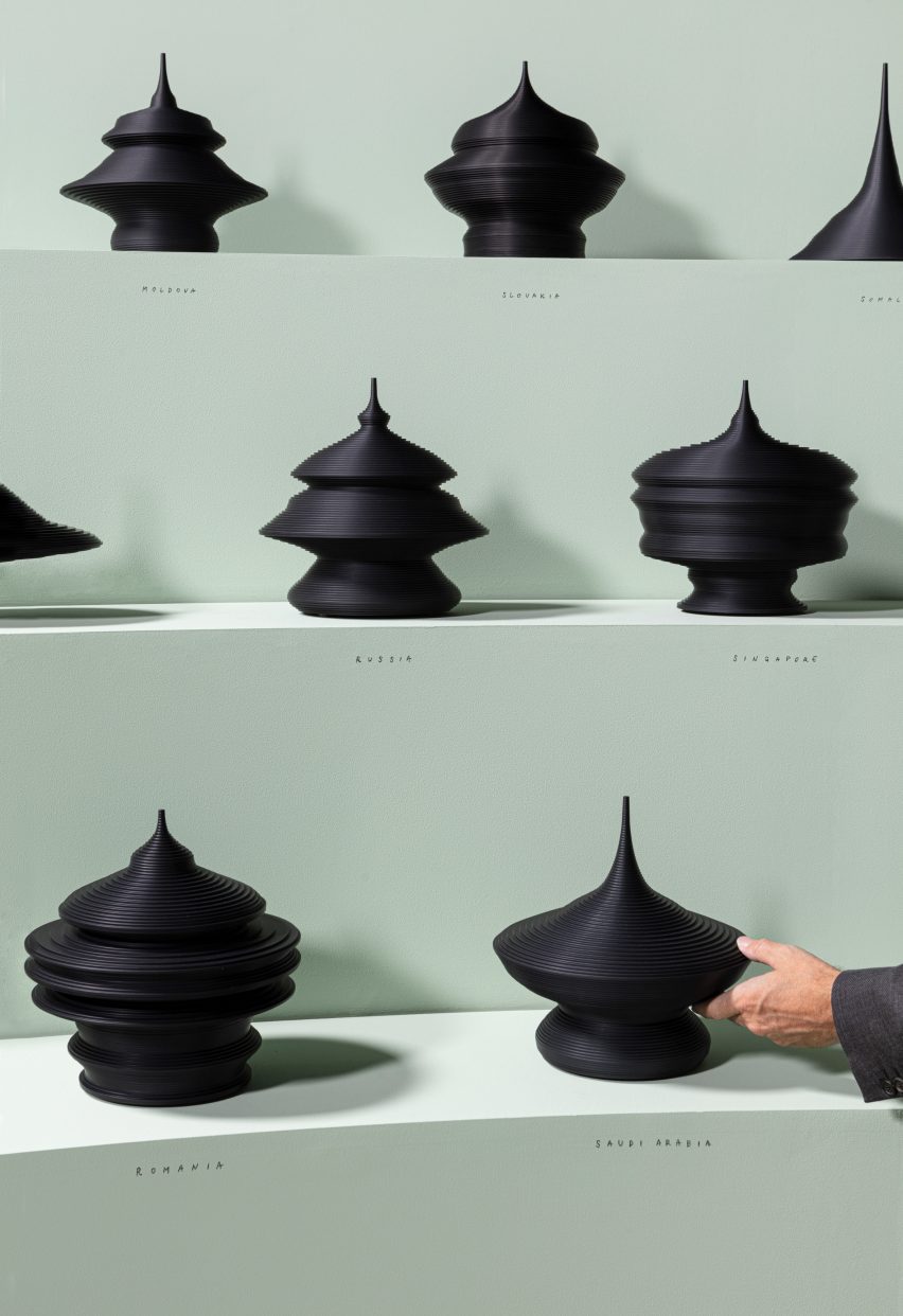 Black sculptures on green shelves