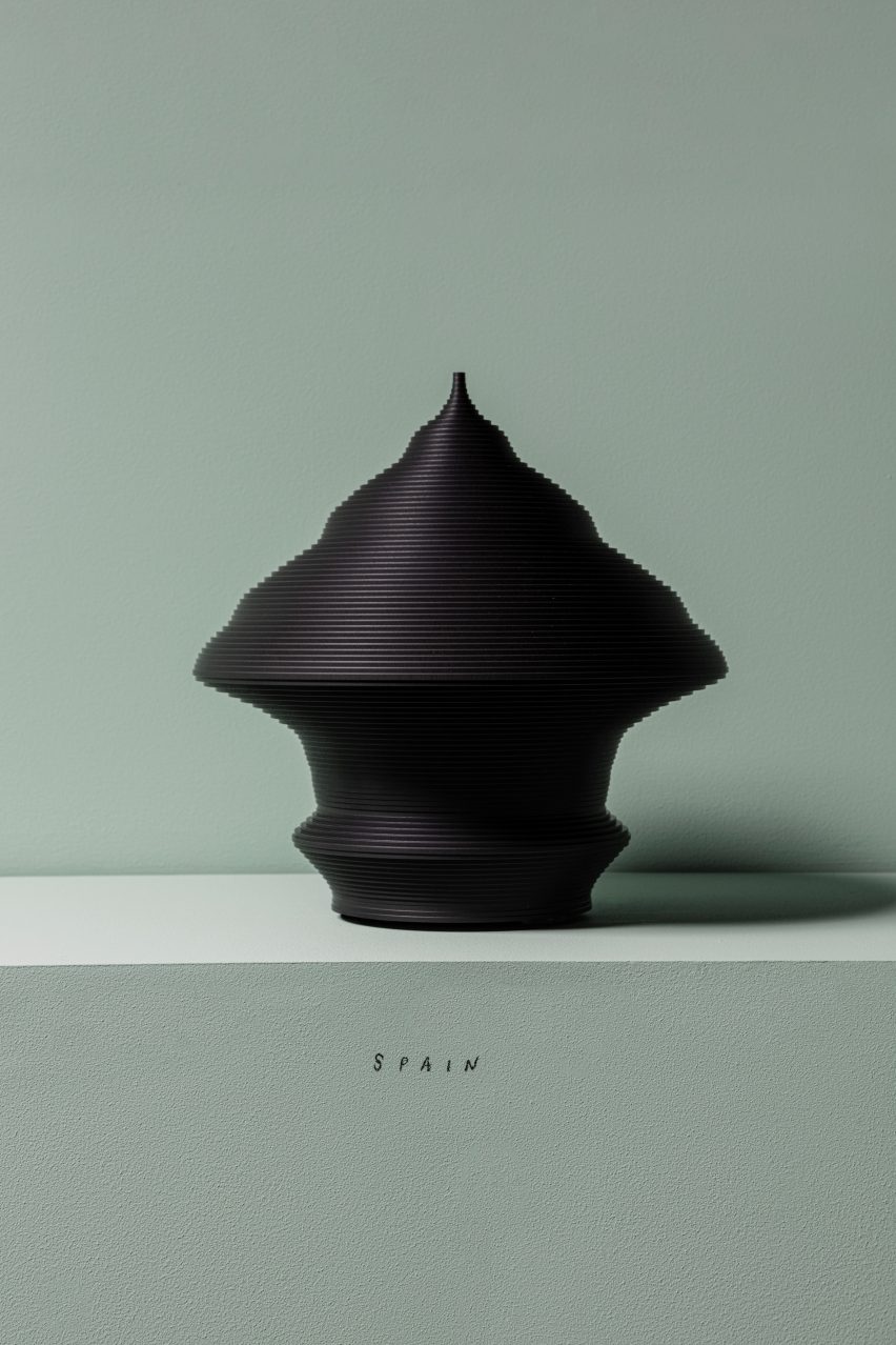 A black sculpture shaped like a pyramid