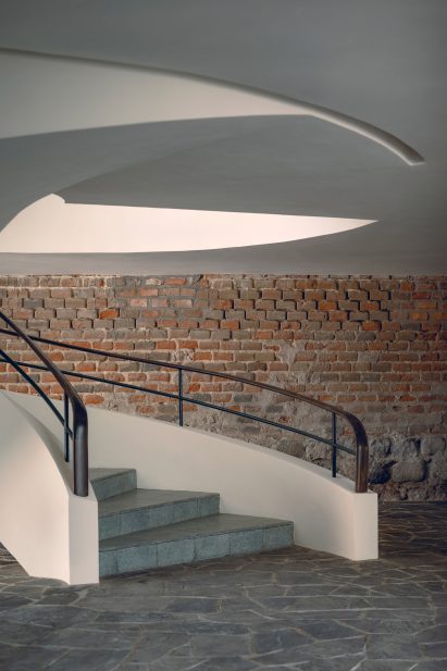 Spiral staircase and brick walls