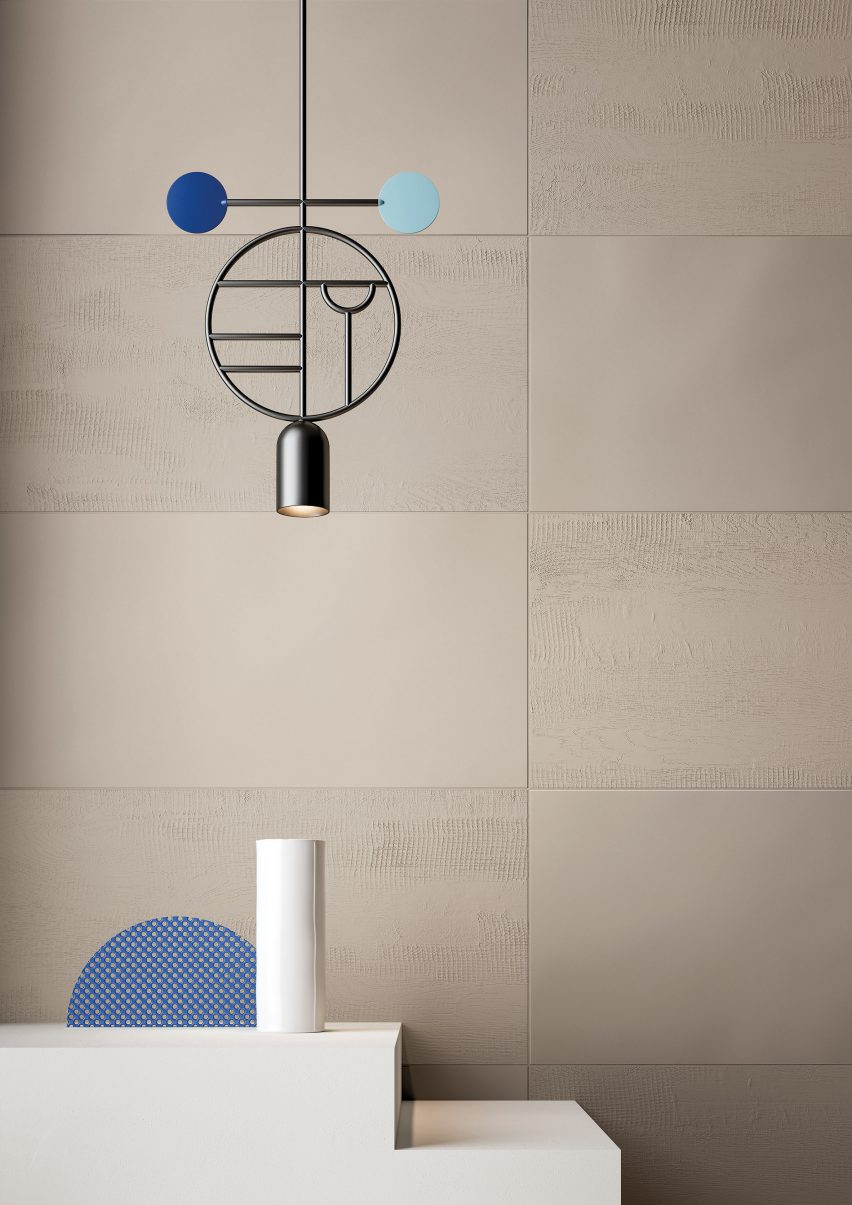 The Dune colour with the relief finish used as a wall tile, with a pendant light hanging in front of the wall