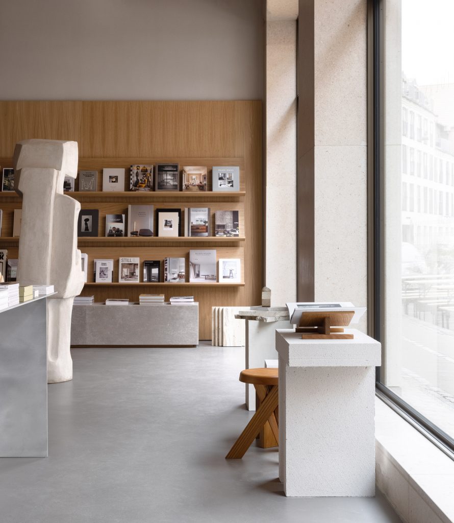 Stone sculpture in wood-panelled bookstore