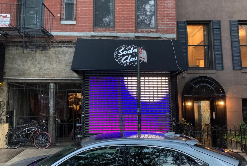 A shopfront with purple lighting