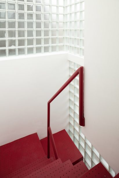 Red stairway with glass-block walls in Maryland House by Remi Connolly-Taylor