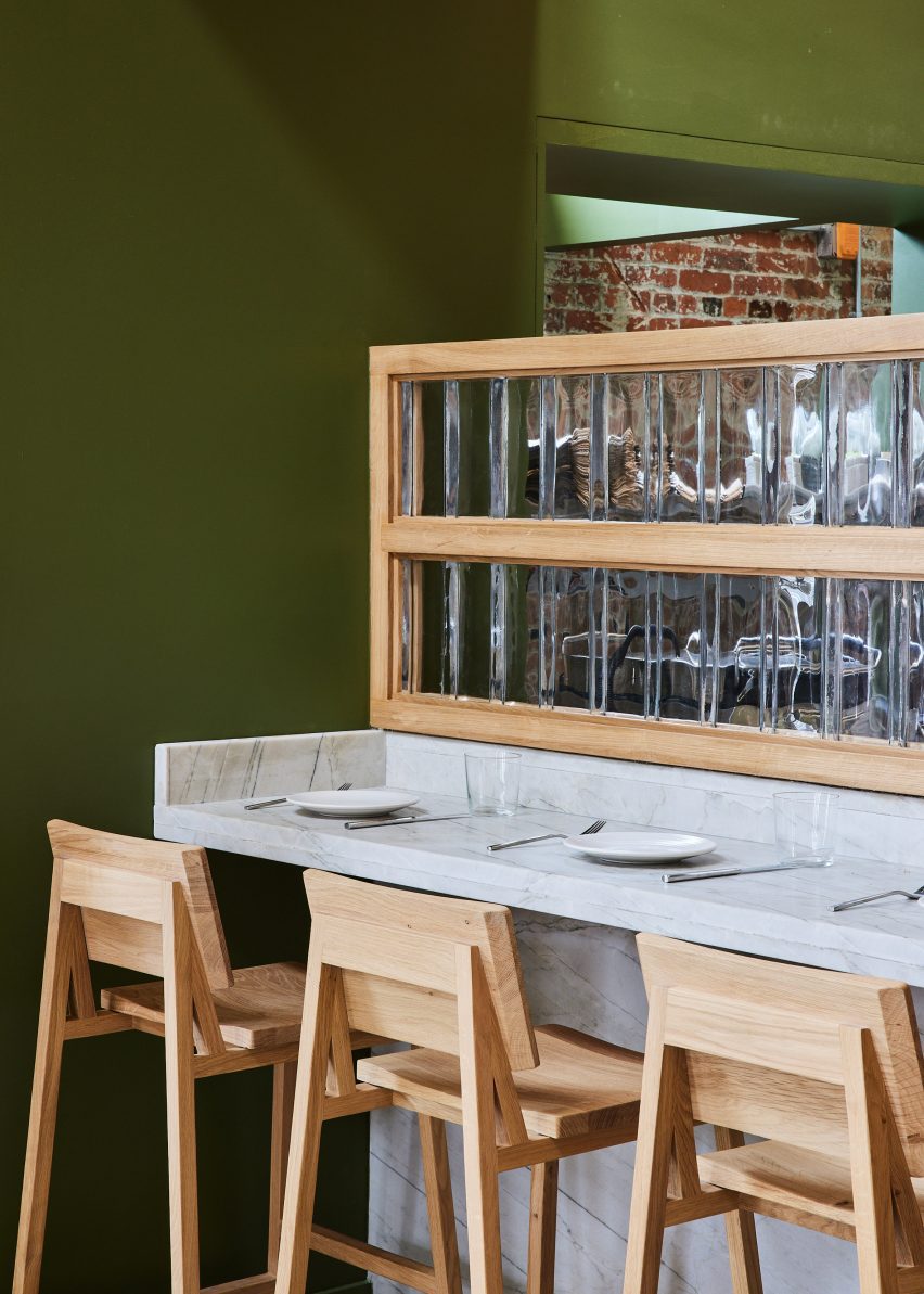 Marble chef's counter with wooden stools