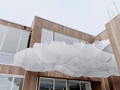 Open roof structure made from aluminium covers outdoor terrace of Softie House