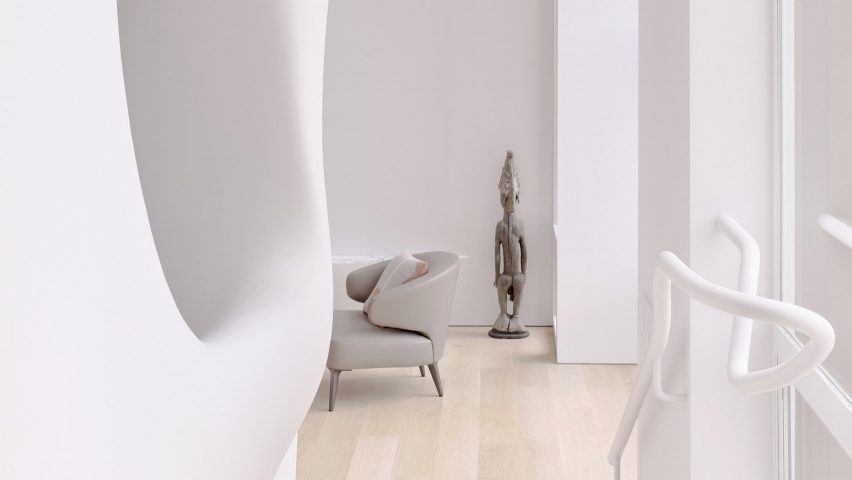 Curving white walls and grey chair in Softie house by OPA