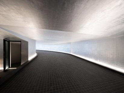 Concrete and black-tiled entrance