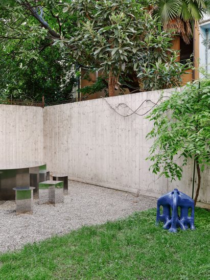 The Sunnei Palazzina courtyard includes furniture and art