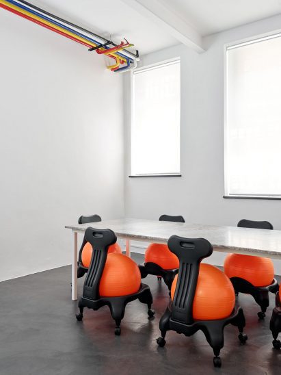 Chairs fitted with exercise balls were placed at a stone table