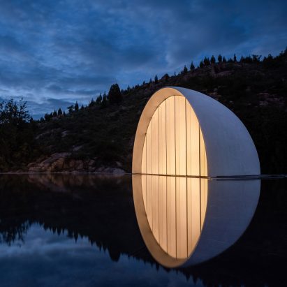 A half domed volume emerges from a pool of water