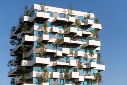 The building is wrapped in concrete and glass bands