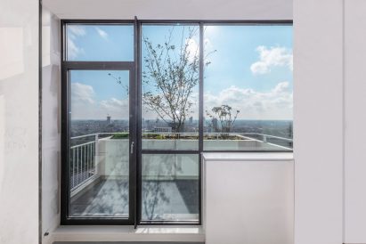 A glazed wall leads out to a terrace at Trudo Vertical Forest