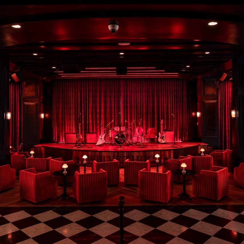 A dark room with red lighting and furniture