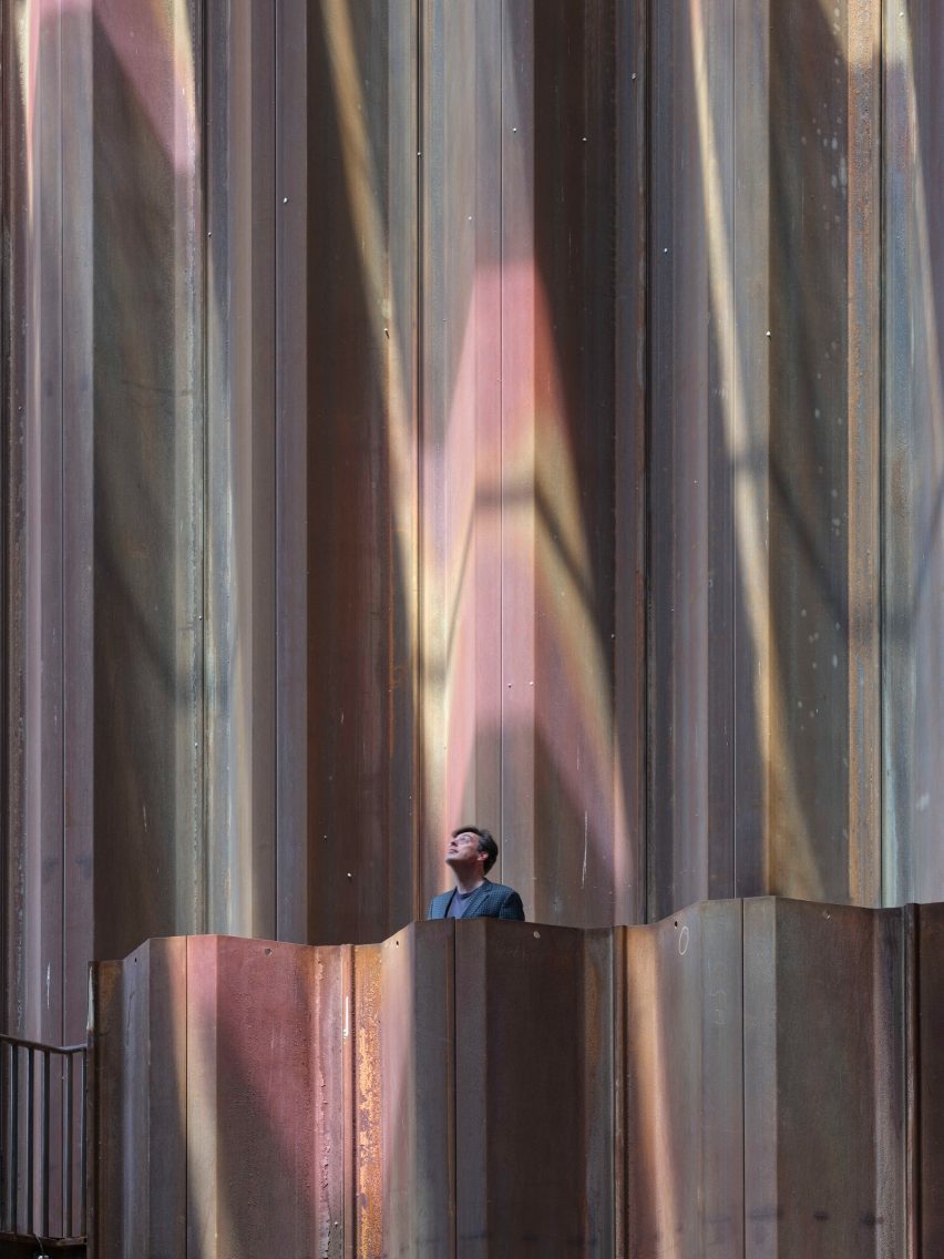 A person stands under coloured, patterned light inside the Dutch Biotope pavilion
