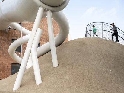 White pipes and tubes connect the buildings and ground