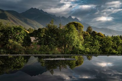A body of water overlooks the mountain range 