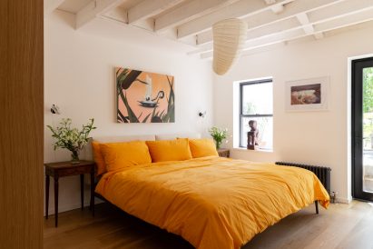 Main bedroom with bright yellow bedding