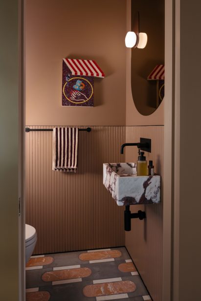 Powder room within millwork block