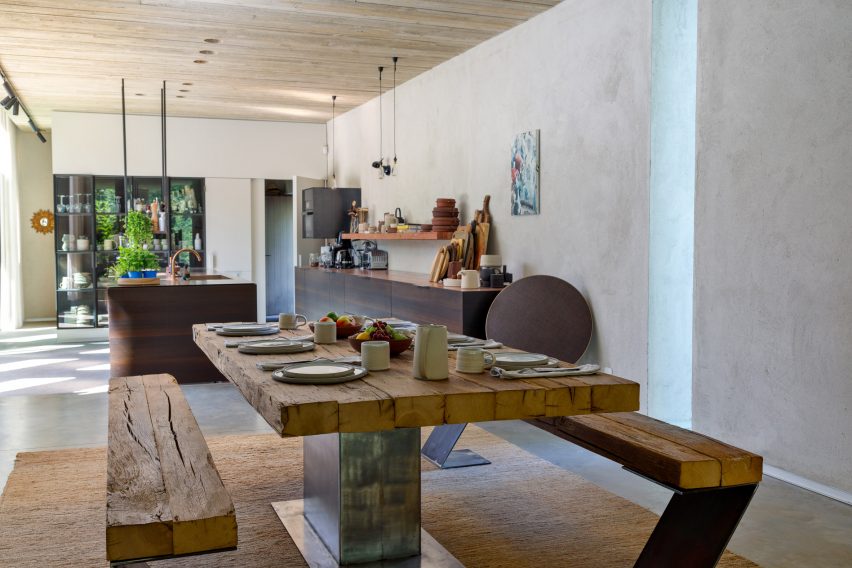 The Bocuse table in a contemporary dining room with dinner plates and cutlery arranged on top