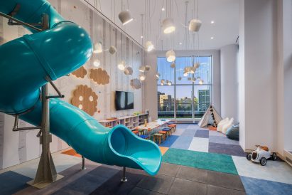 A blue slide fills a play area at Brooklyn Point