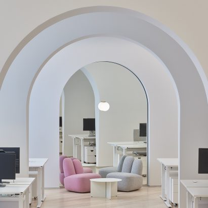A photograph of two Bunny chairs in pink and grey in an office environment
