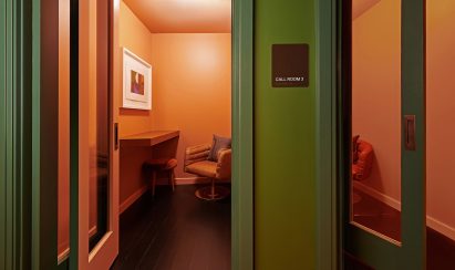 Tangerine-coloured call booths in members' club by AvroKO 