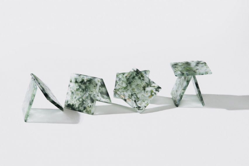 Translucent glass tiles leant against each other in four stacks