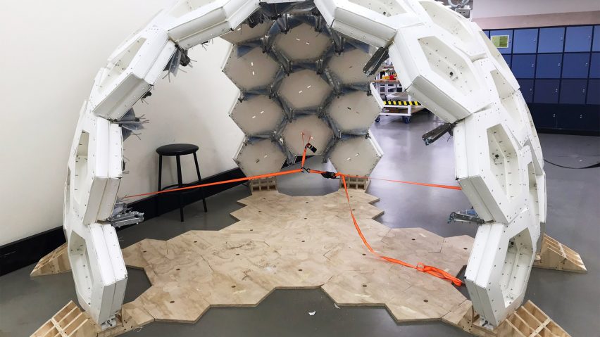 A white spherical shell inside a workshop