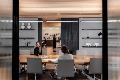Two women sit at a boardroom table
