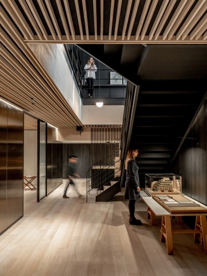 Two employees in an office with oak flooring