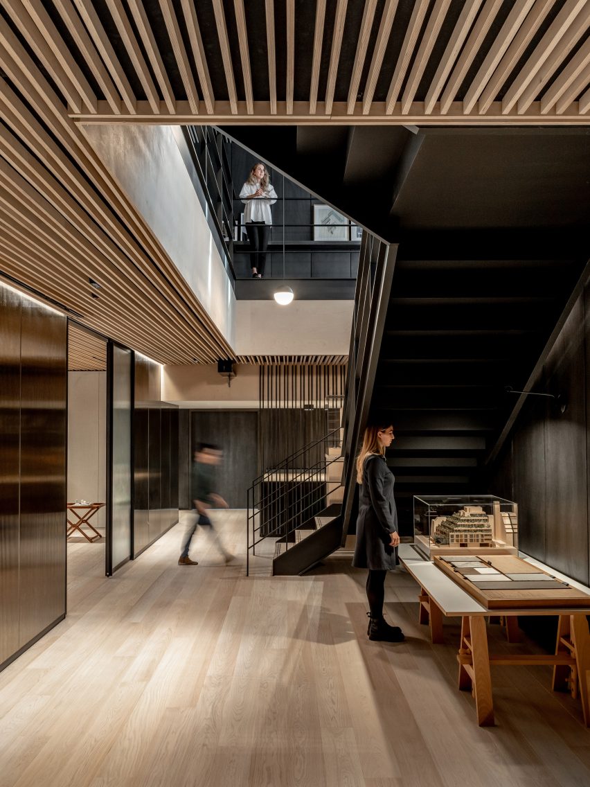 Two employees in an office with oak flooring