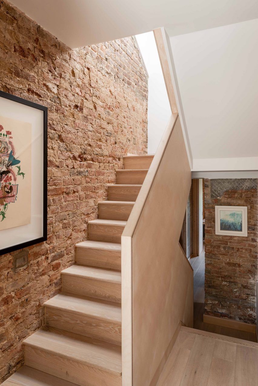 Wooden staircase and exposed brick wall