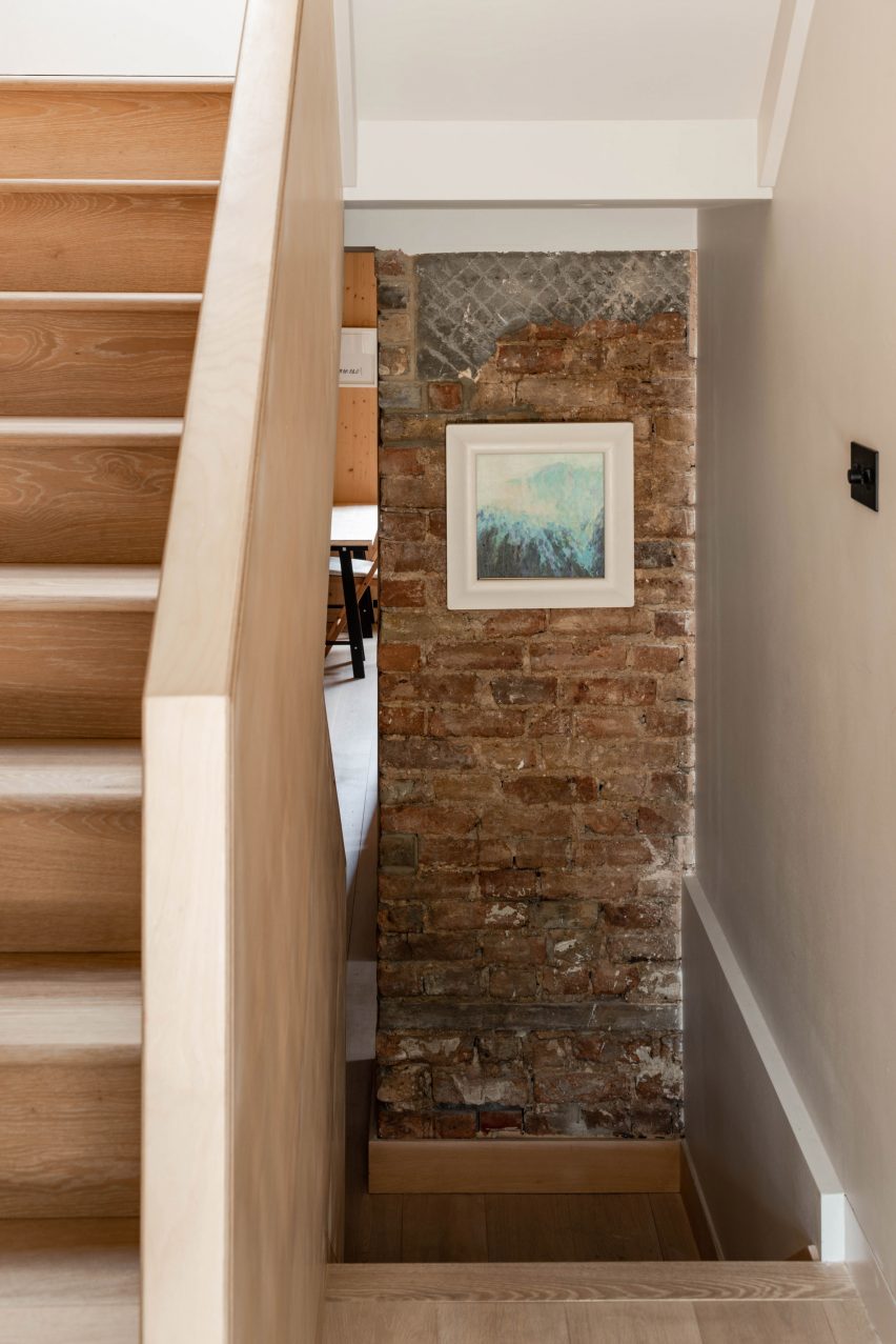Wooden staircase and exposed brick wall