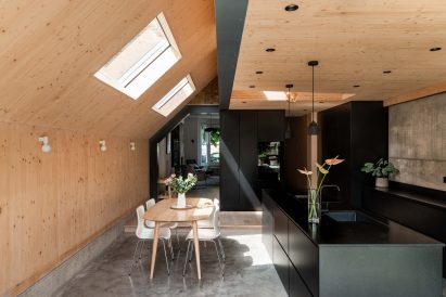 Open plan kitchen with wooden walls