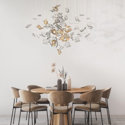 Lasvit's Dancing Leaves glass lighting sculpture in light amber and clear hanging above a residential dining table