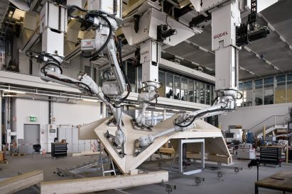 Robots at ETH Zurich fabrication lab hold wooden panels together to make a complex geometric structure