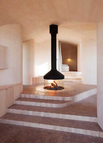 Basalt walls curve around a fluted fireplace